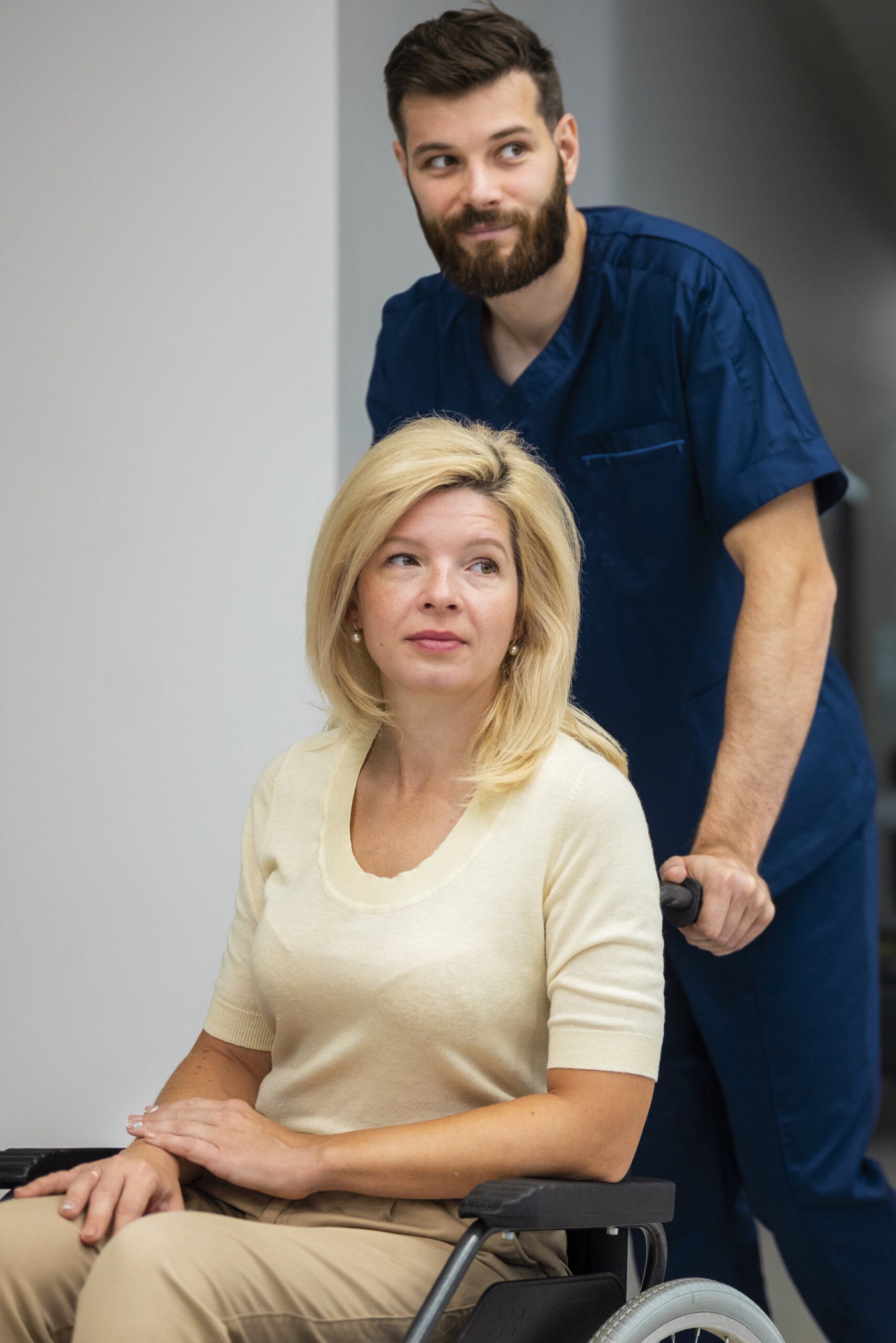 side-view-nurse-helping-patient-wheelchair-2-scaled.jpg